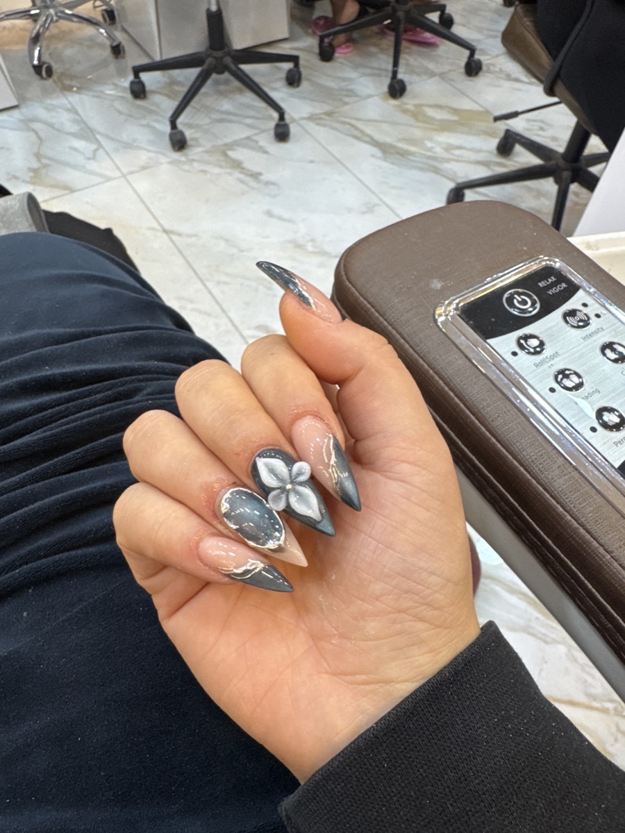 Grey chrome stiletto nails with a 3D flower detail